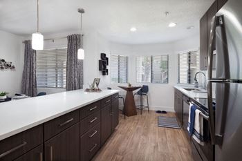 A kitchen with a sink and a refrigerator